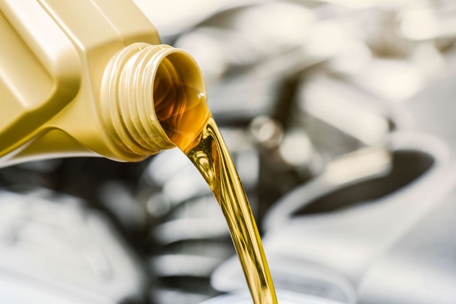 Yellow motor lubricant being poured